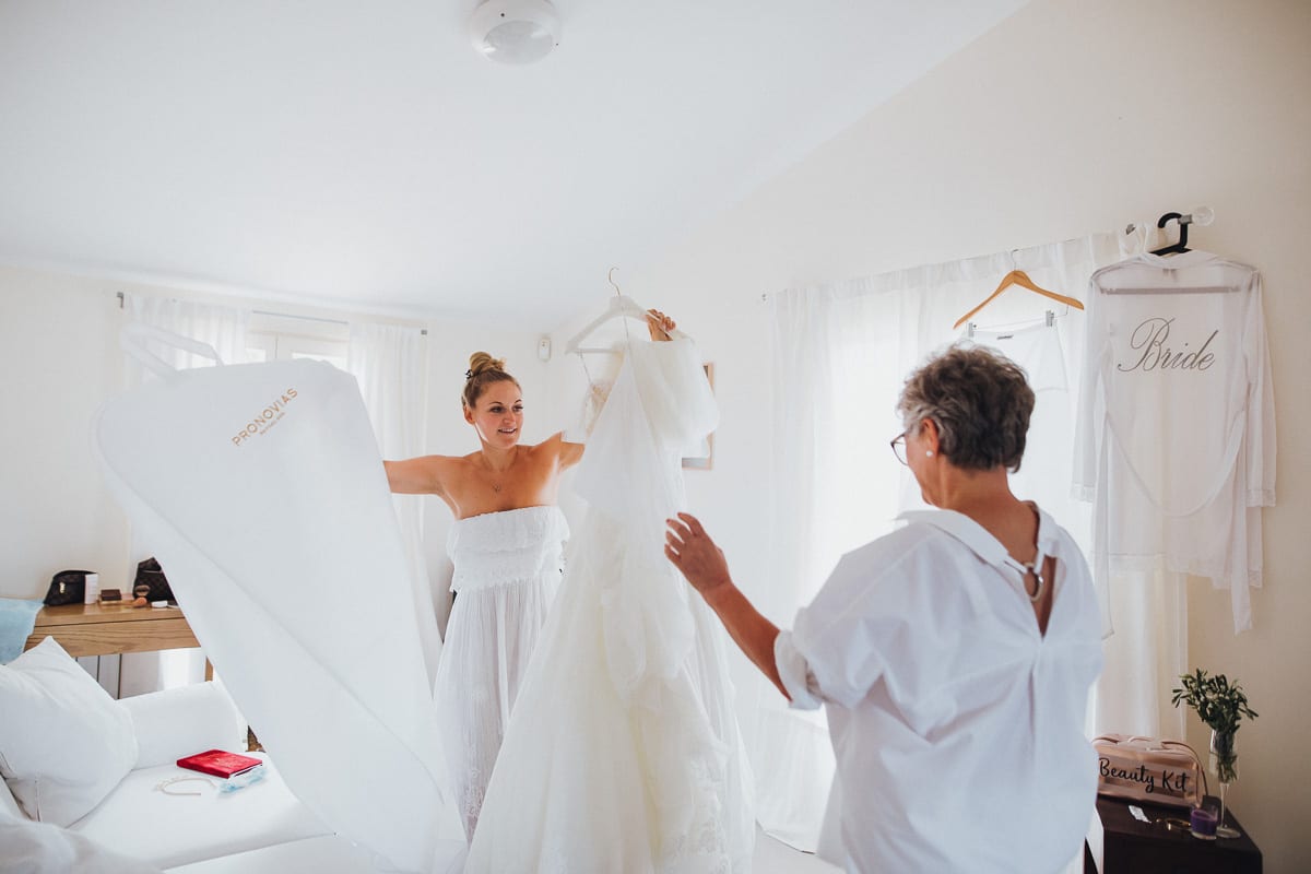 The bride and her mother unpack the wedding dress.