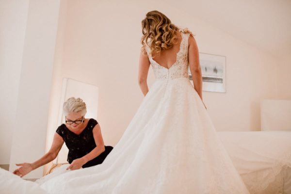 The bride´s mother and the bride in wedding dress.