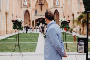 The groom is waiting at the entrance of the church.