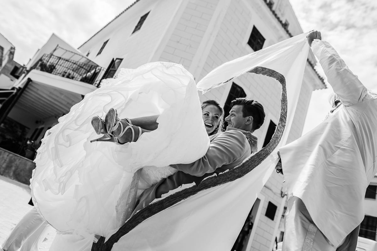 The groom carries his bride through the cut-out heart.
