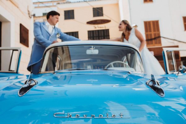 The bride and groom shortly before they start to drive in their the vintage oldtimer car back to the wedding finca.