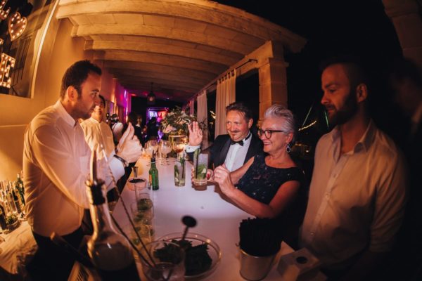 Happy interaction with the parents of the bride and the waiters.
