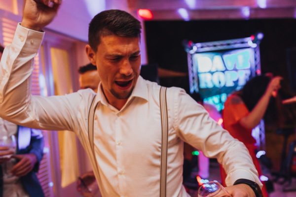The groom's friend rocks the dance floor.