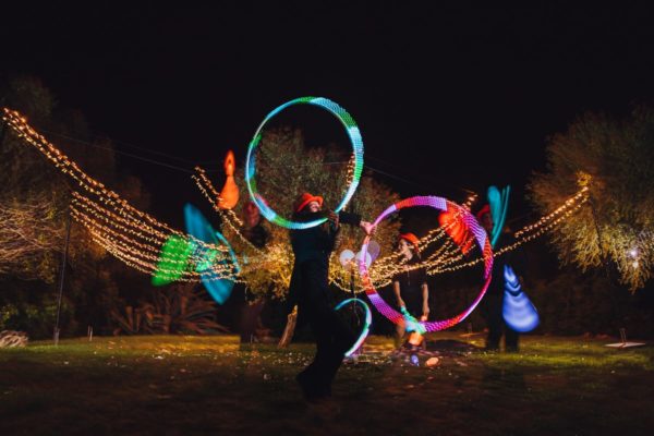 Double exposure of the light artists at night as a light program.
