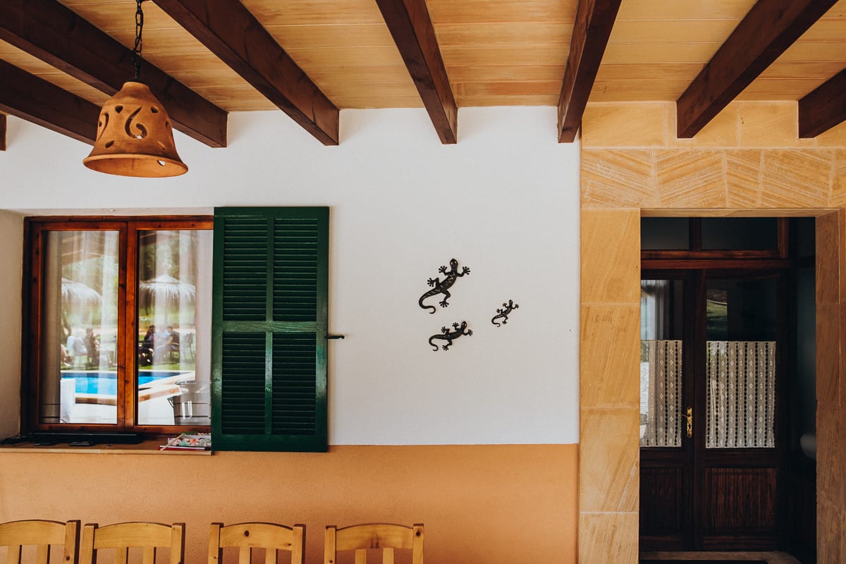 Detail of the entrance of the Finca Can Toni with the breakfast guests reflecting in the window.
