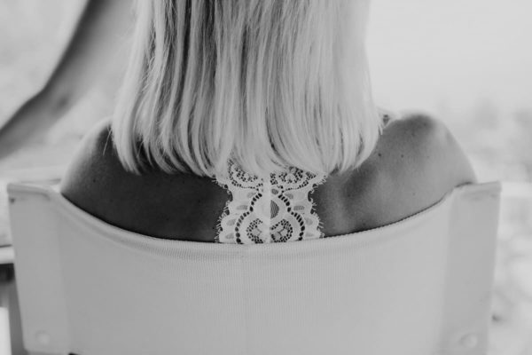 Close up of the bride from behind seeing a beautiful lace.