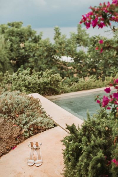 Bridal shoes with view of the swimming pool.