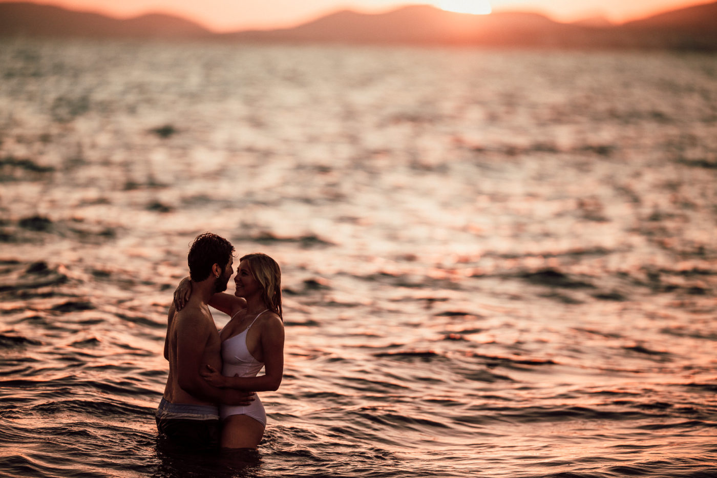 Young couple in love standing in the sea in Mallorca.