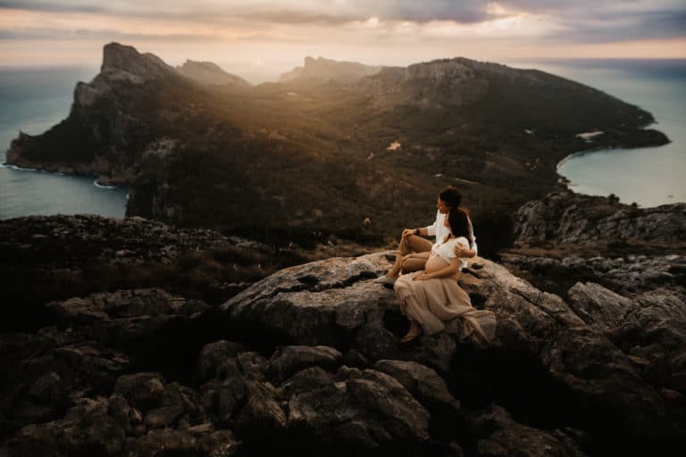 Pregnant couple in front of the beautiful countryside of Formentor.