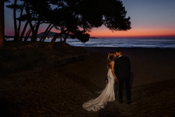 Bridal couple on the beach in Mallorca with the sunrise